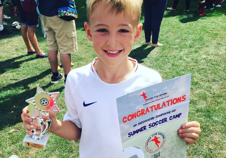 child with trophy and certificate